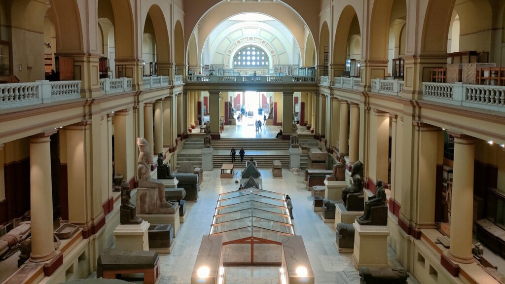 Interior of the Egyptian Museum in Cairo with ancient artifacts and statues on display.