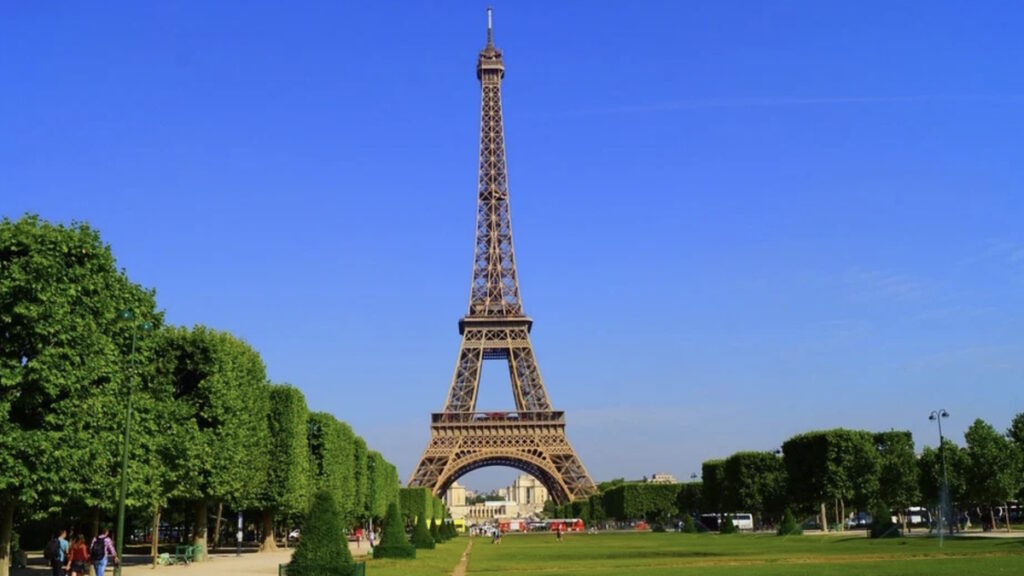 The Eiffel Tower rising above the Champ de Mars park in Paris France.