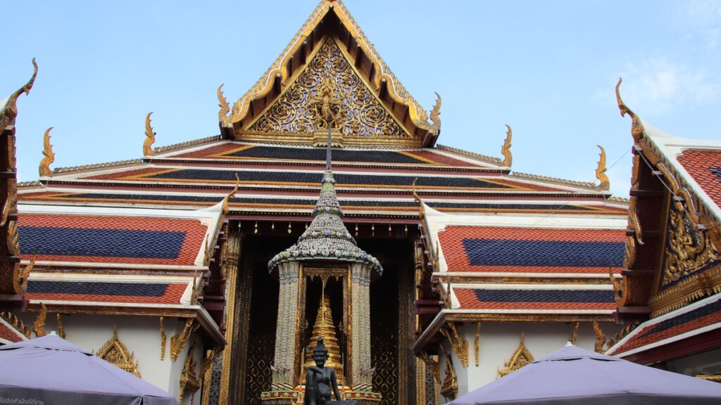 Ornate temple at the Grand Palace in Bangkok Thailand with golden details and traditional architecture.