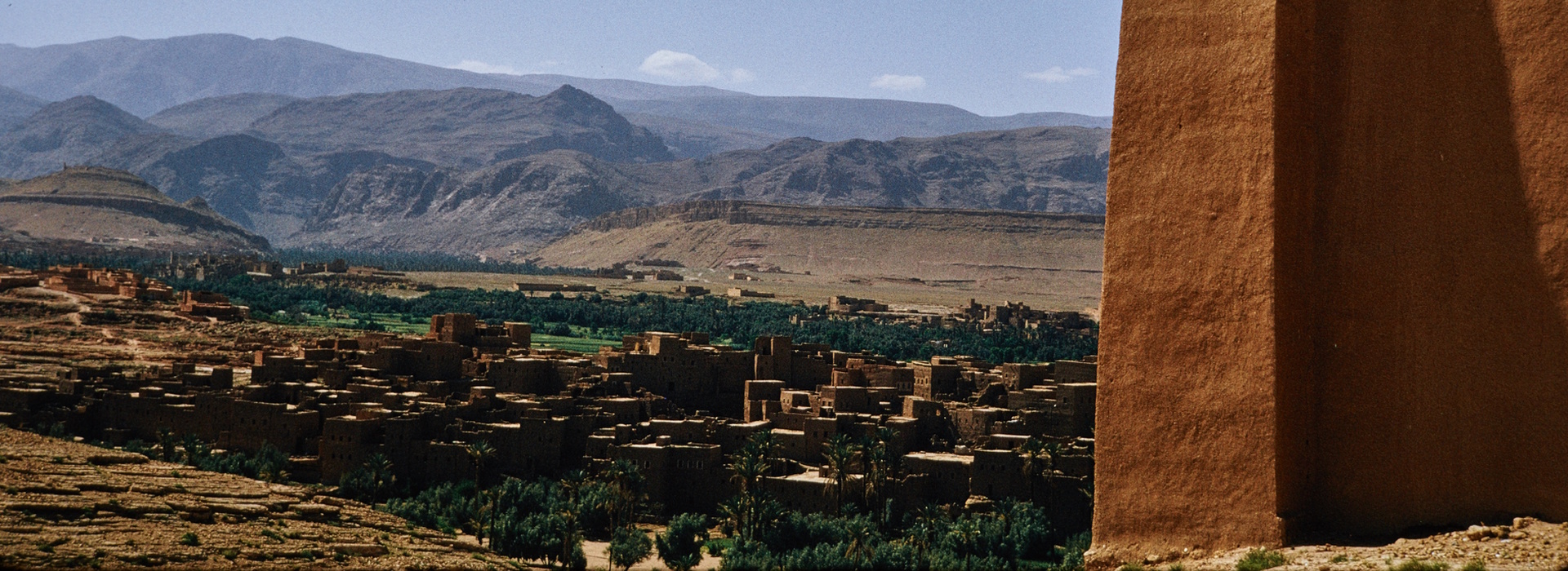 Traditional Moroccan kasbah overlooking a desert village in the Atlas Mountains of Morocco.