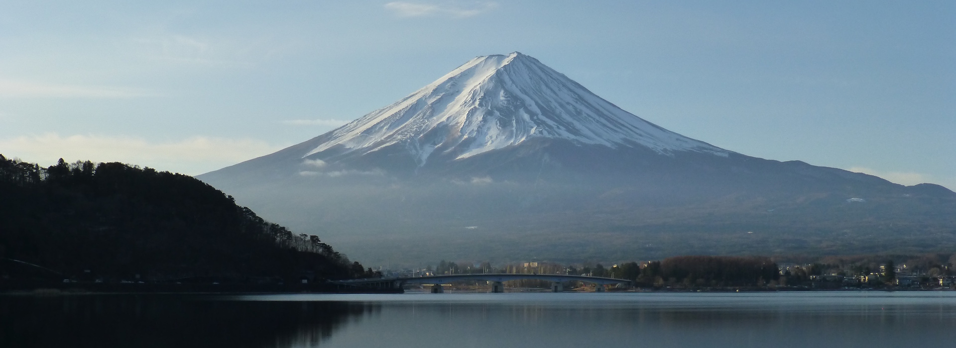 Mount Fuji reflected in a calm lake with snow-covered peak in Japan