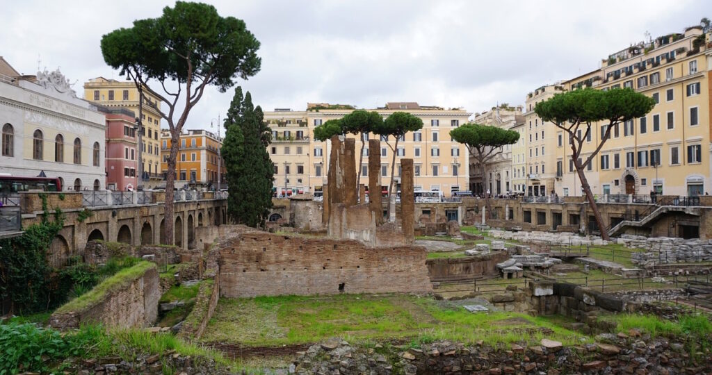 Ancient Roman ruins surrounded by historic buildings in Rome Italy.