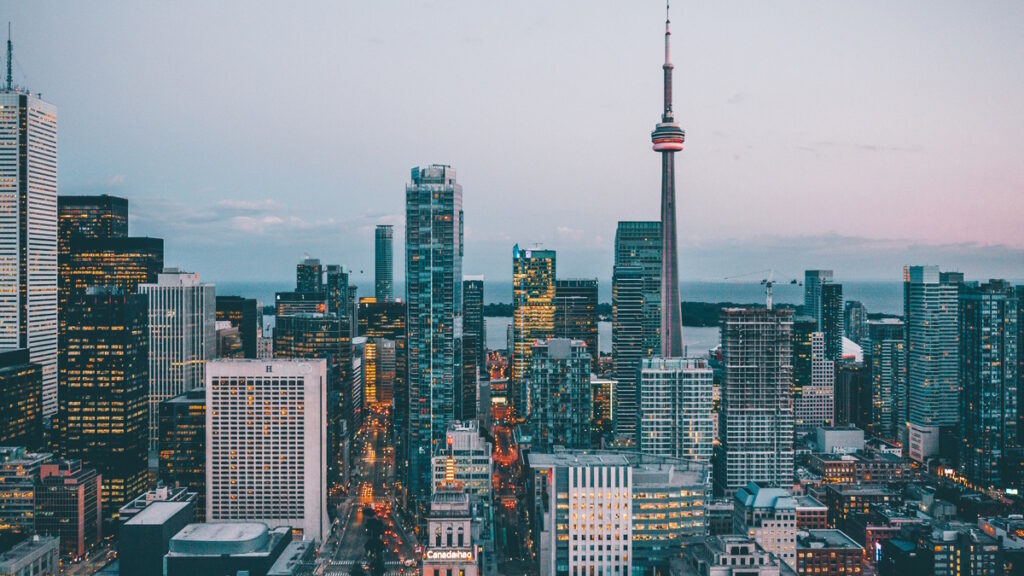 Toronto skyline featuring the CN Tower and downtown skyscrapers at sunset