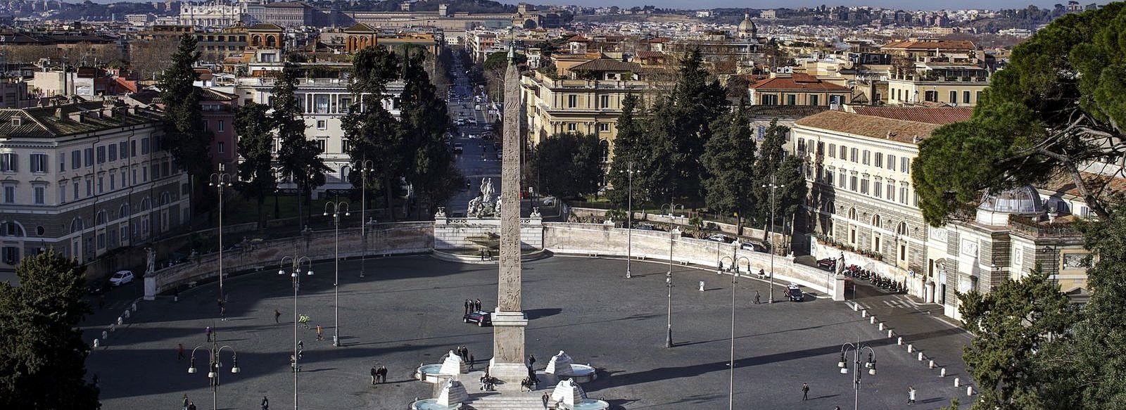 High angle panoramic view of the historic Piazza del Popolo in Rome, Italy, featuring the central Egyptian obelisk, fountains, and surrounding city buildings.
